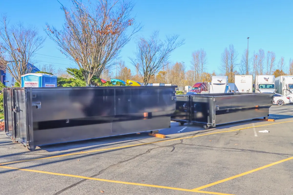 Professional dumpster rental service with roll-off container on residential driveway in North Bay Village